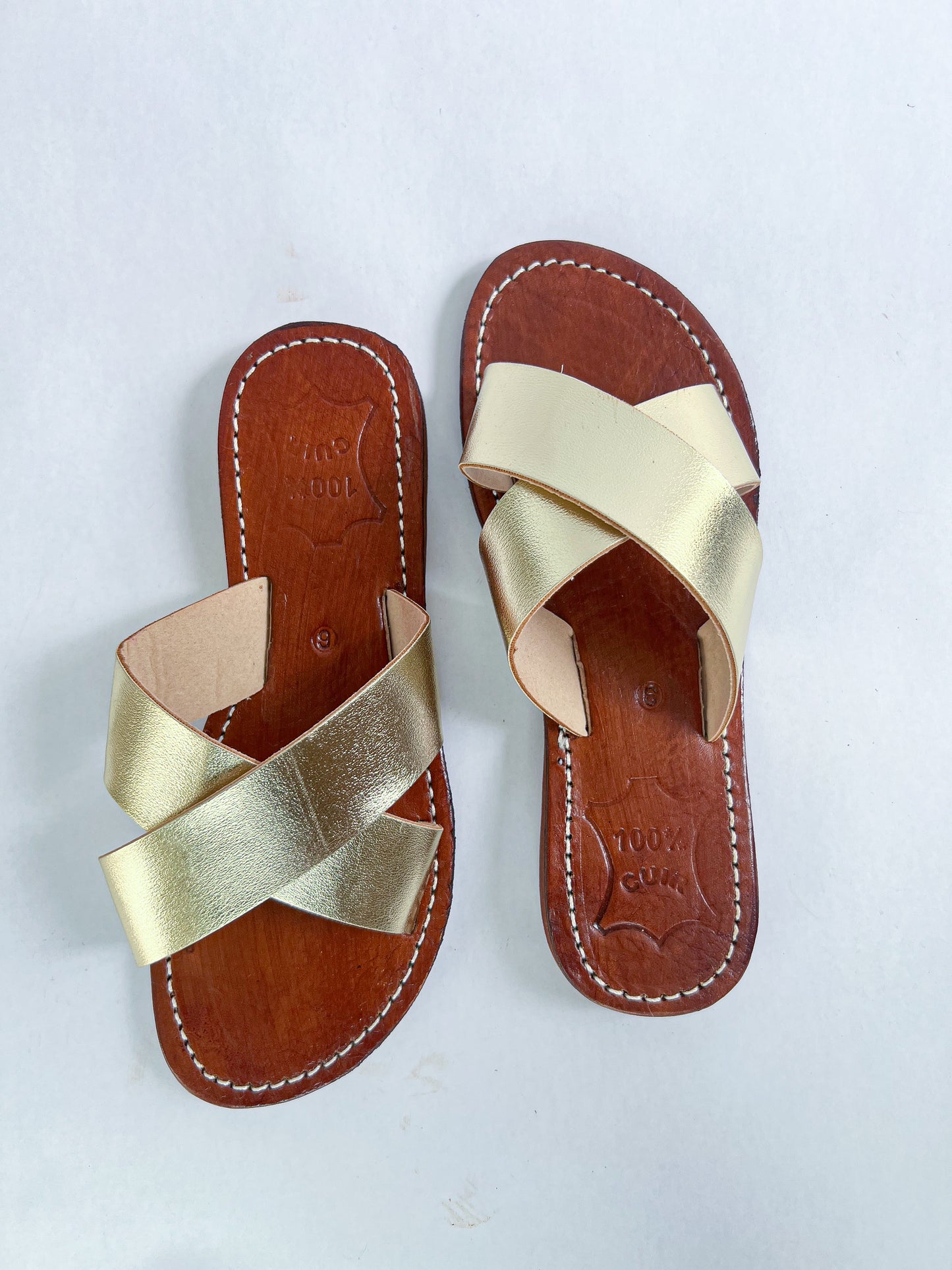 Authentic Idrissi & Burch Moroccan handmade gold leather sandals with decorative stitching.
