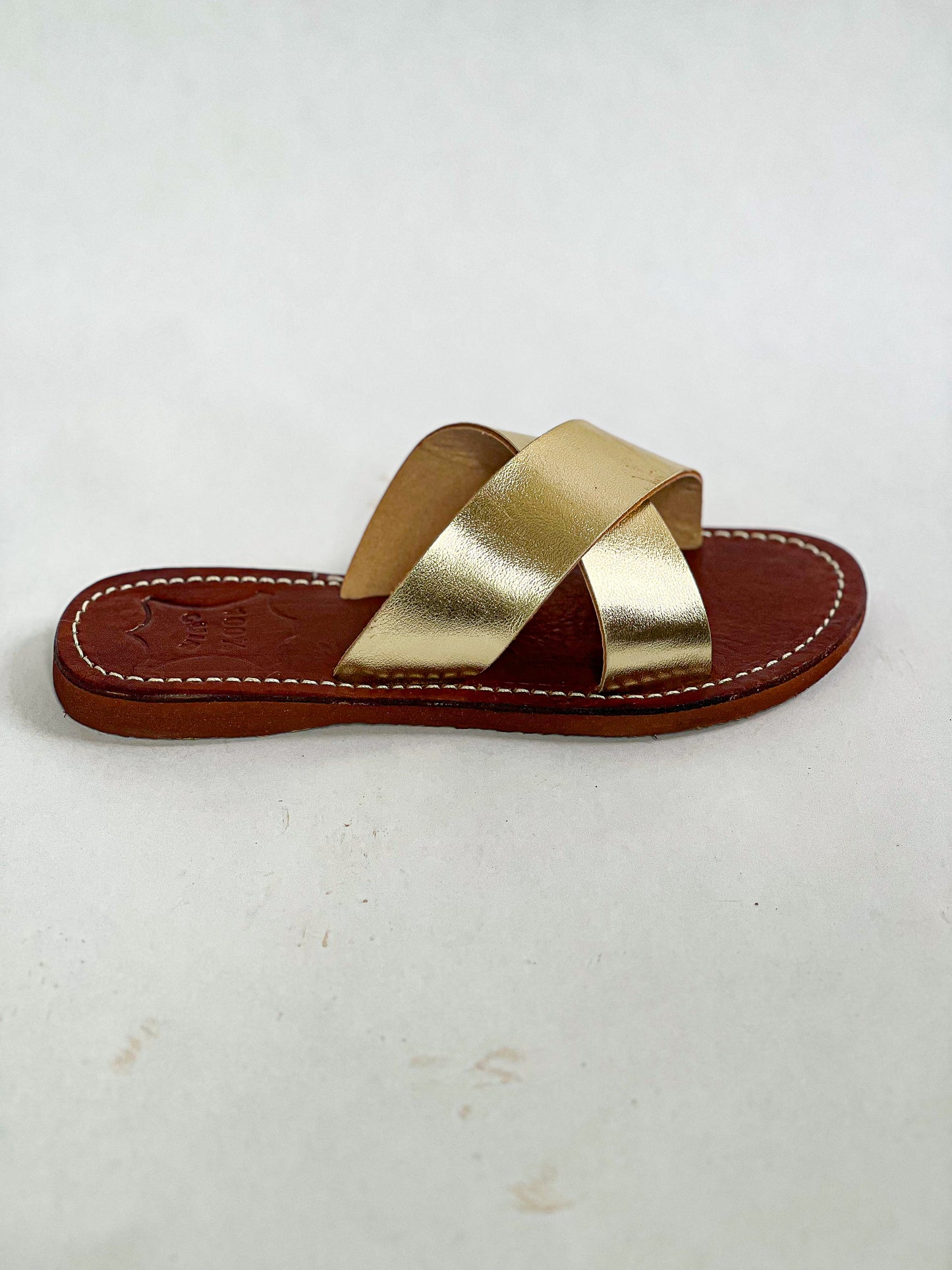 Authentic Idrissi & Burch Moroccan handmade gold leather sandals with decorative stitching.