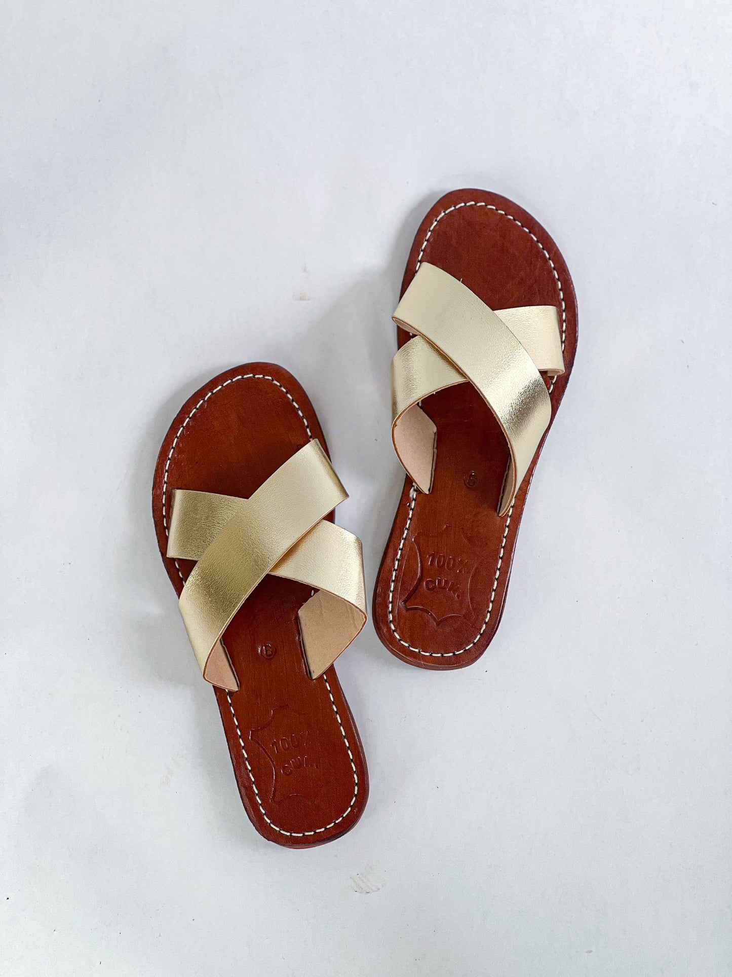 Authentic Idrissi & Burch Moroccan handmade gold leather sandals with decorative stitching.
