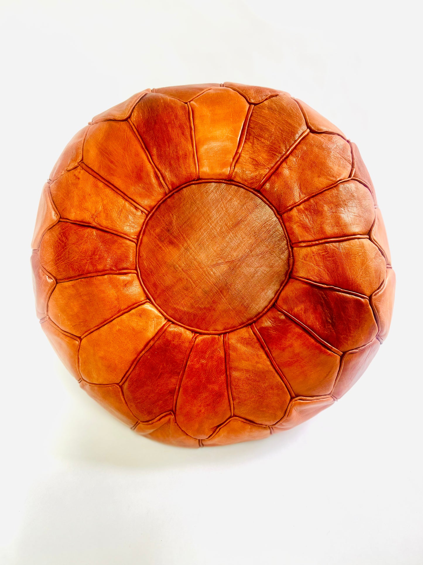 Hand-stitched round Moroccan leather pouf in natural tan, perfect as an ottoman or extra seating.