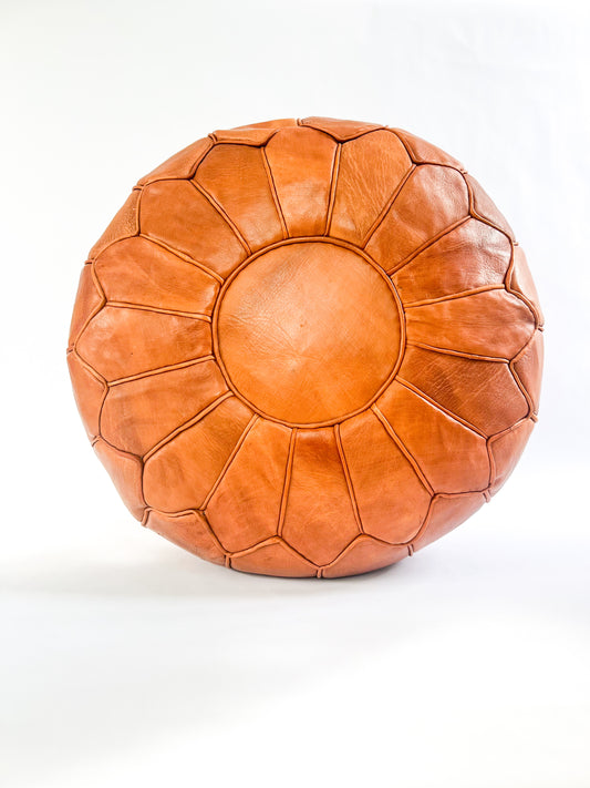 Hand-stitched round Moroccan leather pouf in natural tan, perfect as an ottoman or extra seating.