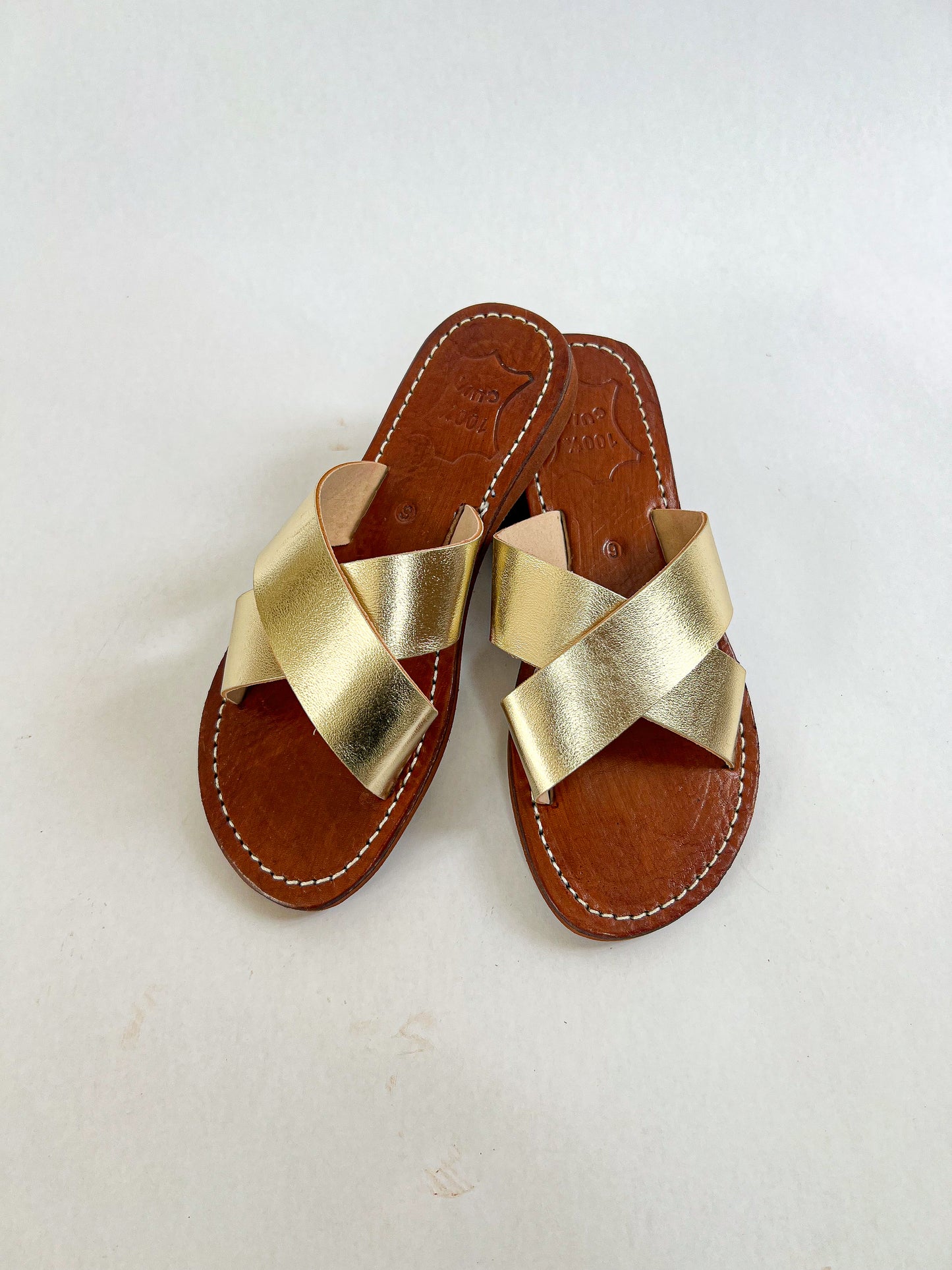 Authentic Idrissi & Burch Moroccan handmade gold leather sandals with decorative stitching.