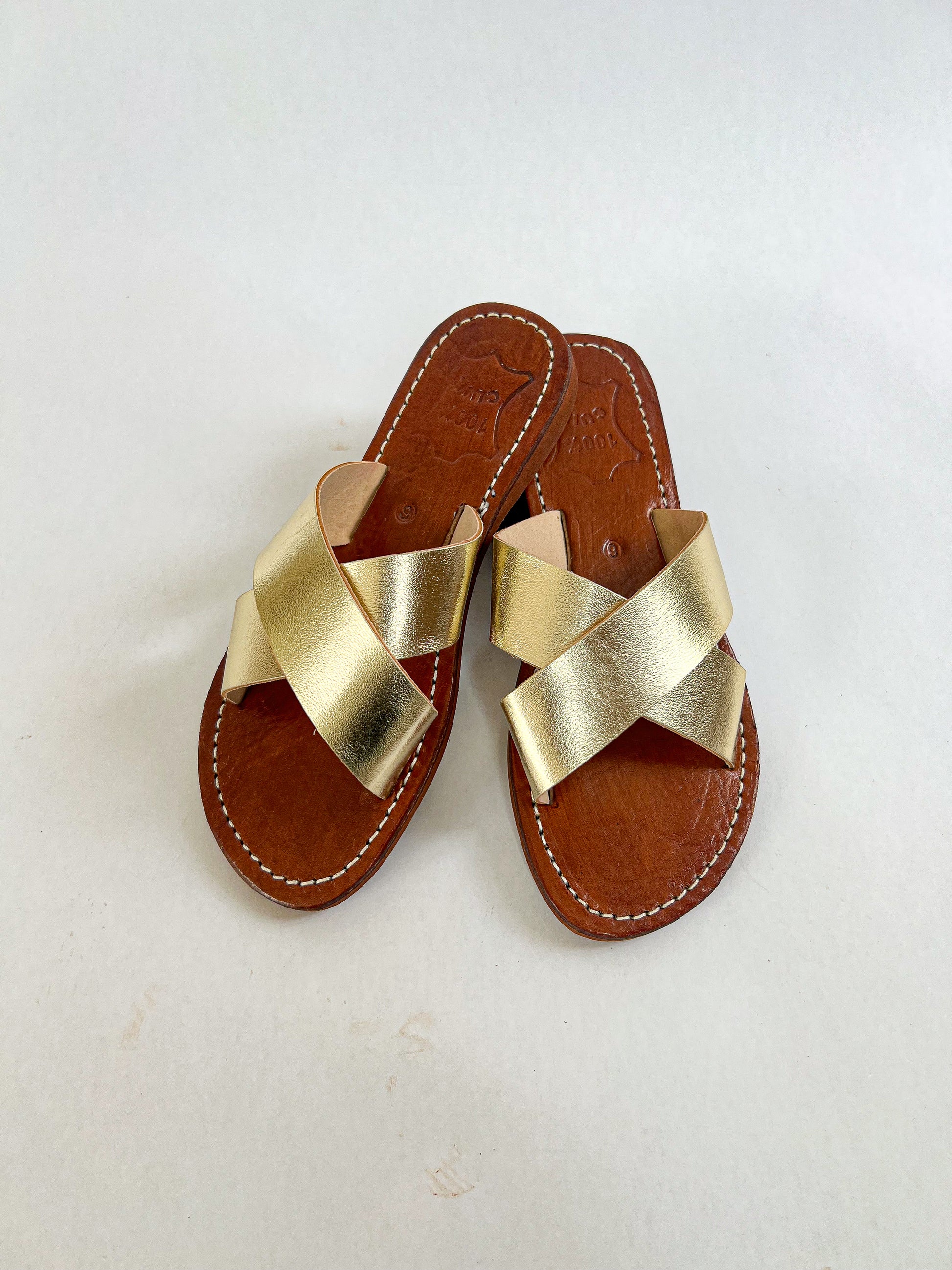 Authentic Idrissi & Burch Moroccan handmade gold leather sandals with decorative stitching.